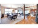 Open-concept living room with a dining table and seamless flow into the living area at 170 Dover Ct, Castle Pines, CO 80108