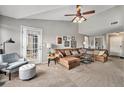 Spacious living room with comfortable seating, ample natural light, and access to an outdoor balcony at 1425 Blue Sky Cir # 15-301, Erie, CO 80516