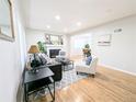 Bright living room featuring a fireplace, hardwood floors, and stylish decor at 1054 Magnolia St, Denver, CO 80220