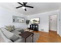 Inviting living room with hardwood floors, a gray sectional sofa, and a stylish media console at 3730 Lowell Blvd, Denver, CO 80211