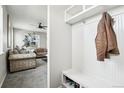 Inviting foyer with a bench and hooks for organization, seamlessly flowing into the living area at 2188 Abigail Ln, Castle Rock, CO 80104