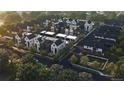 An aerial view showcasing a neighborhood with modern designed townhomes and well-maintained landscaping at 625 Lombardi Cir, Louisville, CO 80027