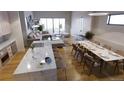 Open-concept space featuring a modern kitchen island, dining area, and comfortable living room seating at 625 Lombardi Cir, Louisville, CO 80027