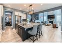 Open-concept kitchen with granite countertops, stainless-steel appliances, and views to the living room at 11657 Olathe St, Commerce City, CO 80022