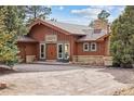 Inviting front exterior showcasing a double door entry and beautiful brick accents at 12493 Forest Canyon Dr, Parker, CO 80138