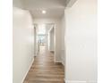 Bright hallway with wood-look flooring leading to other rooms at 6156 Hourglass Dr, Brighton, CO 80601