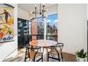 Bright dining area with a round table, four chairs, and a large window at 903 E 13Th Ave, Denver, CO 80218