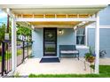 A cozy front porch with seating offers a welcoming entrance to this beautifully maintained light blue home at 1019 26Th St, Denver, CO 80205