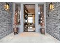 Stunning front entrance with stone accents and an open view to the living room at 3219 Castle Butte Dr, Castle Rock, CO 80109
