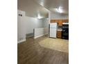 Open-concept space with hardwood floors connecting a bright living area to the adjacent kitchen at 4580 W Alameda Ave, Denver, CO 80219