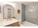 Updated bathroom features a tub, vanity with marble countertop and stylish mirror at 8335 Fairmount Dr # 7-208, Denver, CO 80247