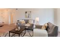 Bright living room showcasing hardwood floors, modern furnishings, and neutral tones at 8335 Fairmount Dr # 7-208, Denver, CO 80247