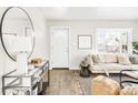 Welcoming entryway with a large circular mirror and contemporary console table at 185 S Eliot St, Denver, CO 80219