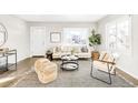 Bright living room with neutral tones, large windows, modern furniture, and stylish decor at 185 S Eliot St, Denver, CO 80219