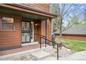 Inviting front entrance with decorative security door, brick landing, and convenient handrail at 8095 Garrison Ct # B, Arvada, CO 80005