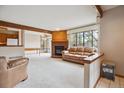 Inviting living area featuring a brick fireplace, large window and open layout at 8095 Garrison Ct # B, Arvada, CO 80005