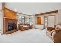 Spacious living room with a cozy brick fireplace and large windows for natural light at 8095 Garrison Ct # B, Arvada, CO 80005
