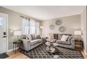 Comfortable living room featuring stylish seating, modern decor, and hardwood floors at 7604 Reed St, Arvada, CO 80003