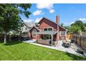 A beautiful backyard features a well-manicured lawn, hot tub, patio with outdoor furniture, and a privacy fence at 8051 W 78Th Cir, Arvada, CO 80005