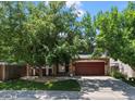 Charming two-story home with brick and siding, mature trees, and a two car garage at 8051 W 78Th Cir, Arvada, CO 80005