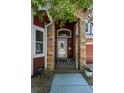 Close up view of a front door with stone archway and decorative glass at 8051 W 78Th Cir, Arvada, CO 80005