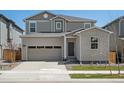 Charming two-story home with a brick facade, attached garage, and manicured lawn at 552 Red Rock Pl, Brighton, CO 80601