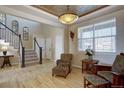 Cozy living room showcases a decorative ceiling, staircase, and plenty of natural light at 11918 S Hitching Post Trl, Parker, CO 80134