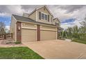 Spacious three-car garage, complemented by brick accents and a well-maintained lawn at 18225 E Caley Dr, Aurora, CO 80016