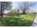 Attractive brick home with lush front lawn, mature trees and landscaping providing curb appeal at 2 Larkdale Dr, Littleton, CO 80123