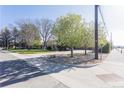 A bright street view showcasing the home's location, mature trees, and well-maintained landscaping at 2 Larkdale Dr, Littleton, CO 80123