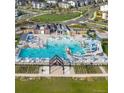 Aerial view of a community pool with water slides, seating and a area at 5983 Fulton St, Denver, CO 80238
