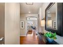 Inviting foyer with hardwood floors leading to a bright living room with a fireplace at 6378 Noble Ct, Arvada, CO 80403