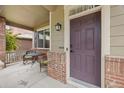 Welcoming covered front porch with brick accents and seating area at 41 Jordan Ln, Erie, CO 80516