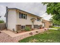 Side view of a charming house with manicured landscaping and a walkway at 744 Memphis St, Aurora, CO 80011