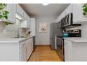 Functional kitchen features white cabinetry, stainless steel appliances, and a stainless steel sink at 1531 S Owens St # 23, Denver, CO 80232