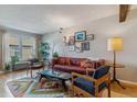 Bright living room with hardwood floors, decorative rug, and comfortable seating arrangement at 1531 S Owens St # 23, Denver, CO 80232