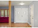 Bright foyer with hardwood floors, a double front door, and a glimpse into the living space at 10200 Julian St, Westminster, CO 80031