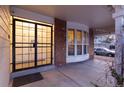 Inviting home entrance with secure iron gate, brick accents, and a bay window for a warm, welcoming appeal at 10200 Julian St, Westminster, CO 80031