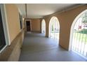 Arched covered porch entrance with gray painted floor and decorative metal security gates at 8220 Lamar Cir, Arvada, CO 80003