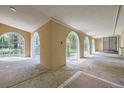 A covered patio featuring arched openings that provide views of the landscaped yard at 8220 Lamar Cir, Arvada, CO 80003