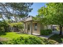 Brick ranch home with attached garage and lush green landscaping at 7329 Windsor Dr, Boulder, CO 80301