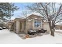 Brick ranch home with attached garage and mature trees, snow-covered landscaping at 7329 Windsor Dr, Boulder, CO 80301