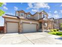 Charming two-story home featuring a two-car garage and inviting front porch at 802 Gamble Oak St, Brighton, CO 80601