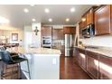 Modern kitchen with granite countertops, stainless steel appliances, and dark wood cabinets at 802 Gamble Oak St, Brighton, CO 80601