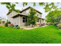 Spacious backyard with a well-maintained lawn and an inviting patio area for outdoor entertainment at 14200 W 86Th Pl, Arvada, CO 80005