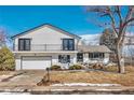 Charming two-story home featuring a balcony, well-maintained lawn, and an attached two-car garage at 6655 W Glasgow Ave, Littleton, CO 80128