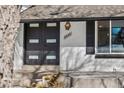 Close-up of the front entrance featuring a modern black double door and updated address plate at 6655 W Glasgow Ave, Littleton, CO 80128