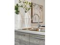 Modern kitchen sink with sleek faucet, complemented by stylish vases and contemporary artwork at 1064 Depew St, Lakewood, CO 80214