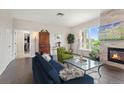 Cozy living room features a stone fireplace, large windows, hardwood floors, and comfortable seating creating an inviting space at 2500 E Cherry Creek South Dr # 313, Denver, CO 80209