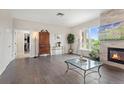 Cozy living room features a stone fireplace, large windows, hardwood floors, creating an inviting space at 2500 E Cherry Creek South Dr # 313, Denver, CO 80209